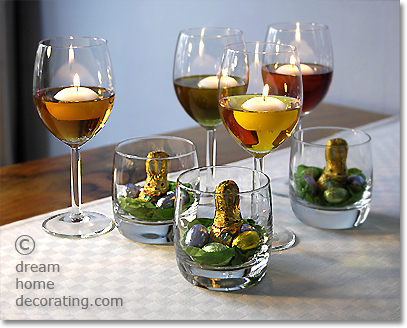 Easter table lights: Centerpieces made of floating candles and mini nests in glass tumblers