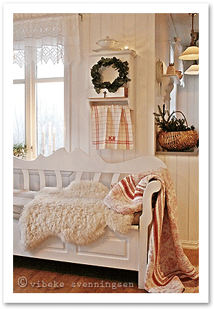 Norwegian kitchen corner with traditional white wooden settee