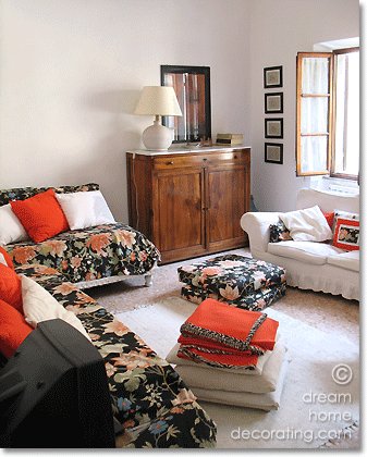 Tuscan townhouse living room in white, black, green and scarlet, San Gimignano, Tuscany, Italy
