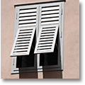 pale grey tuscan shutters on a pink wall